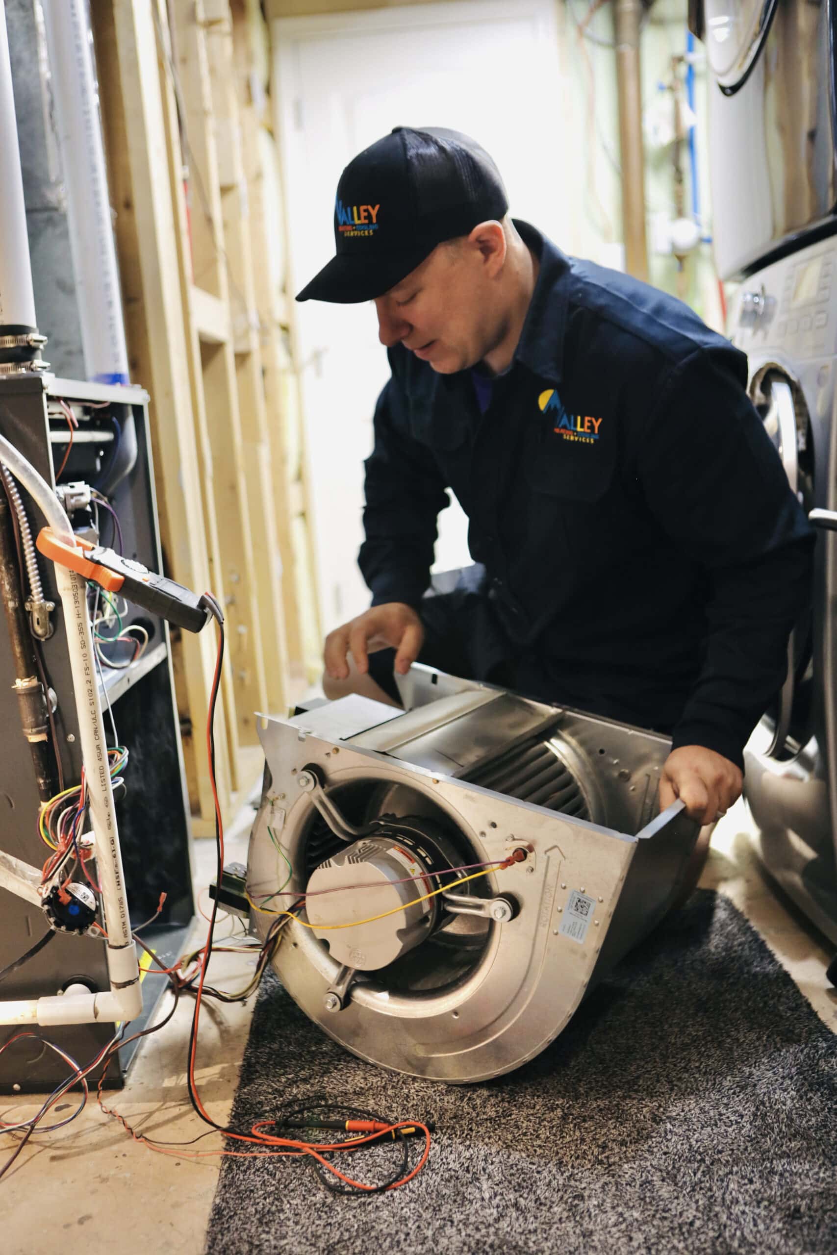 Valley Heating and Cooling technician is repairing a residential furnace.